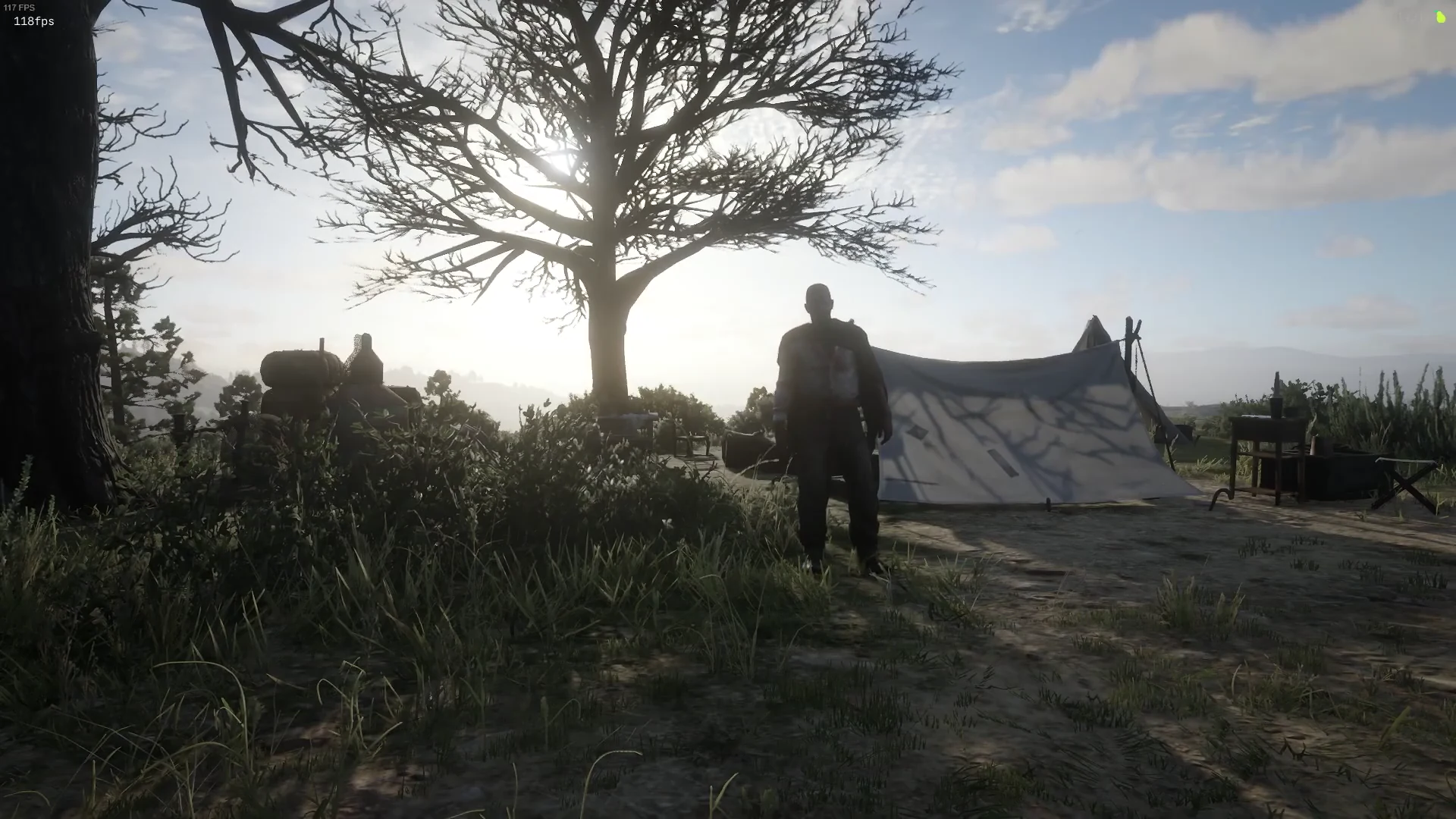 A completed camp scene with a tent, furniture and a campfire area